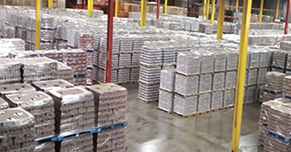 Wrapped pallets inside a supply chain logistics warehouse